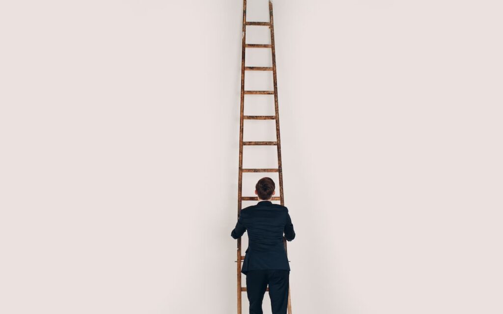 Marketing professional in front of a ladder